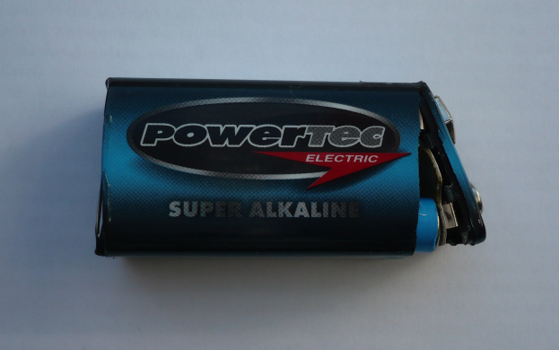 Blue Powertec Super Alkaline battery beschriftet mit "Powertec" in fetter Schrift auf einer weißen Oberfläche.
