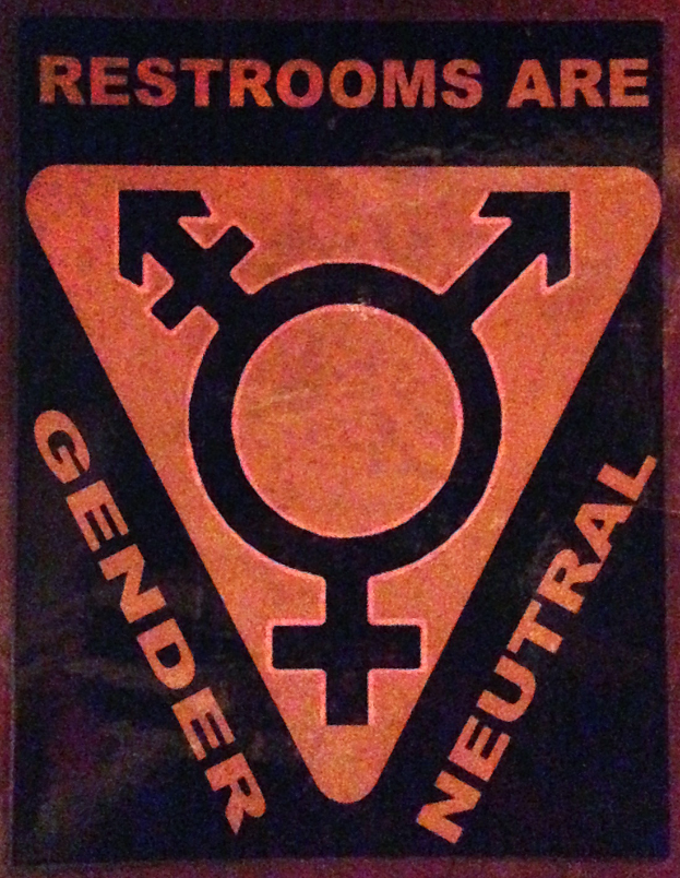 Ein Plakat mit der Aufschrift "Geschlechterneutrale Toiletten" betont die Bedeutung des Geschlechts in der Toilette.